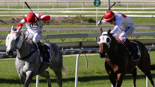 Jim Byrne on Upstart Pride (left) and Jeff Lloyd on Dream Choice at Doomben on Saturday.