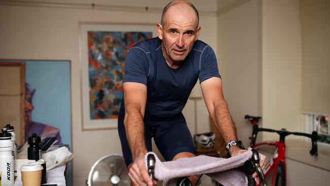 Veteran journalist Rupert Guinness rides a stationary bike in his Edgecliff home in training for the virtual Race Across America in June.