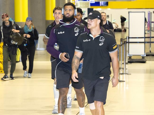 Payne Haas and Kotoni Staggs arrive back at Brisbane Airport after losing to the Rabbitohs. Picture: Richard Walker