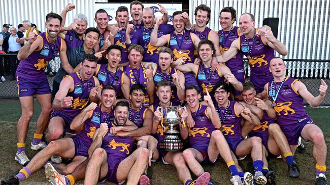 Collegians players celebrate with the trophy. Picture: Andy Brownbill