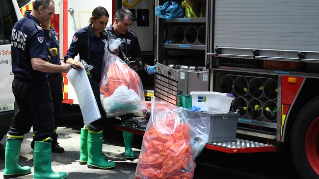 NSW Fire and Rescue workers pack up hazmat material outside 52 Martin Place. Picture: Joel Carrett