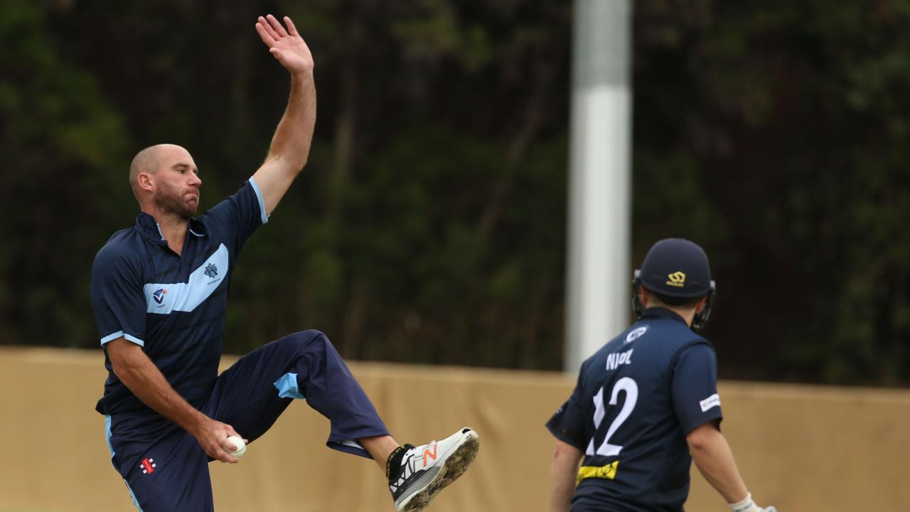 VSDCA - John Hastings hurdles the stumps while bowling for Kew. Picture: Stuart Milligan