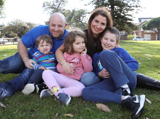 Jacquie and David Wolf from Kingsford with their kids Eitan, Tahlia, and Noah. David says the childcare policy has left services out of pocket and families needing care. Picture: David Swift