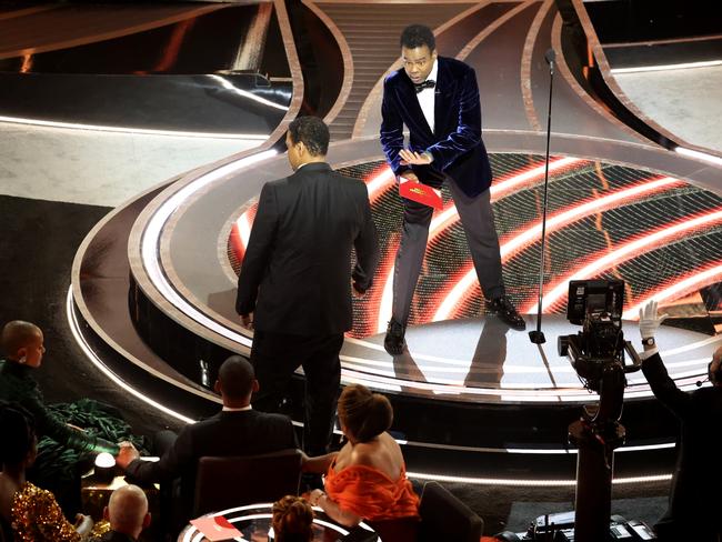 Denzel Washington talks to Chris Rock on stage as Will Smith and Jada Pinkett Smith look on. Picture: Myung Chun / Los Angeles Times via Getty Images