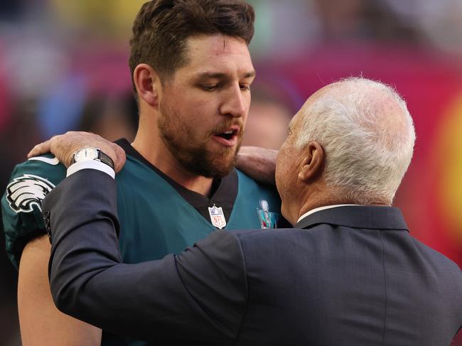 GLENDALE, ARIZONA - FEBRUARY 12: Arryn Siposs #8 and Philadelphia Eagles owner Jeffrey Lurie embrace before Super Bowl LVII between the Kansas City Chiefs and the Philadelphia Eagles at State Farm Stadium on February 12, 2023 in Glendale, Arizona. (Photo by Gregory Shamus/Getty Images)