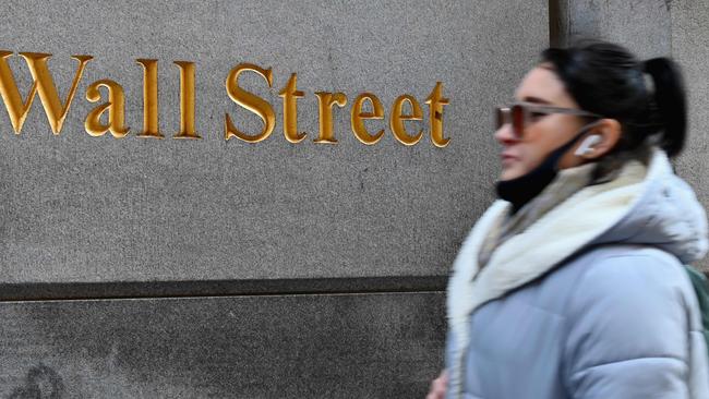 A woman walks past the New York Stock Exchange (NYSE) at Wall Street. Picture: Angela Weiss / AFP