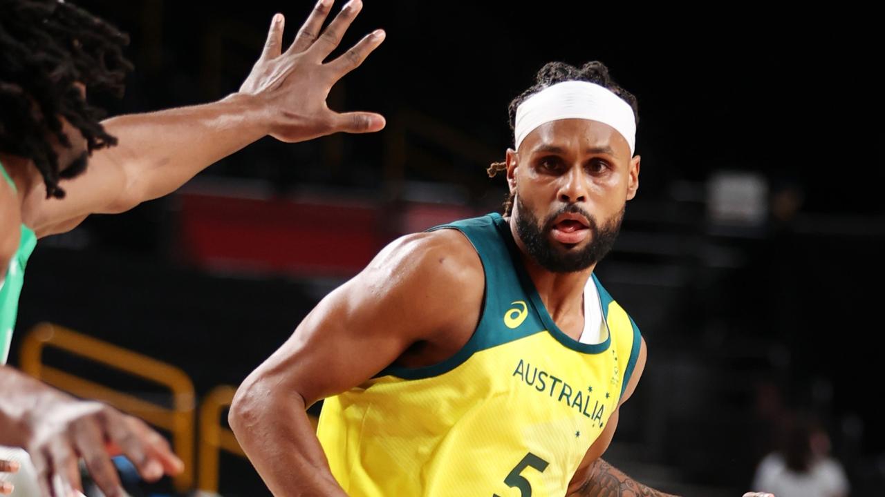 Patty Mills #5 of Team Australia drives to the basket against Nigeria .