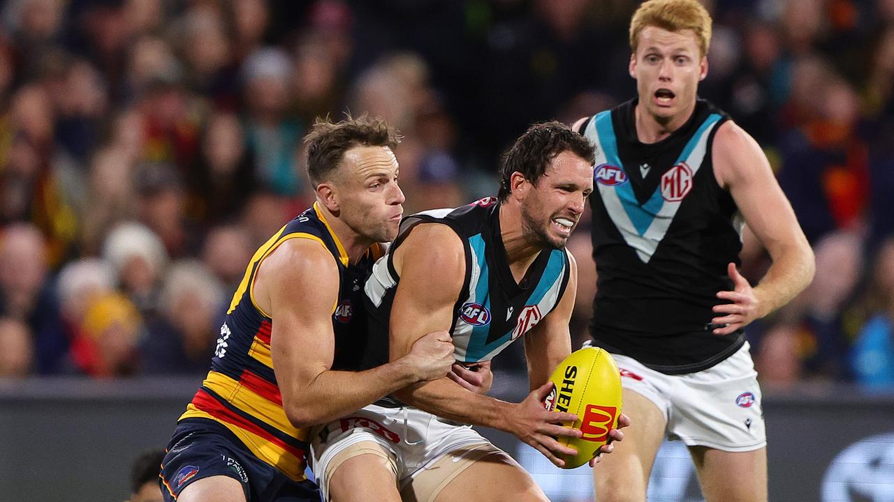 Brodie Smith brings the heat on Travis Boak. Picture: Sarah Reed/AFL Photos via Getty Images