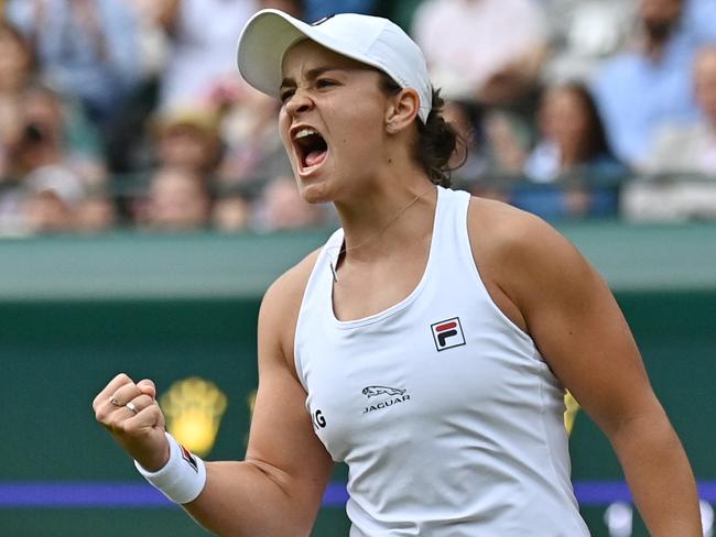 TOPSHOT - Australia's Ashleigh Barty celebrates after beating Czech Republic's Barbora Krejcikova during their women's singles fourth round match on the seventh day of the 2021 Wimbledon Championships at The All England Tennis Club in Wimbledon, southwest London, on July 5, 2021. (Photo by Ben STANSALL / AFP) / RESTRICTED TO EDITORIAL USE