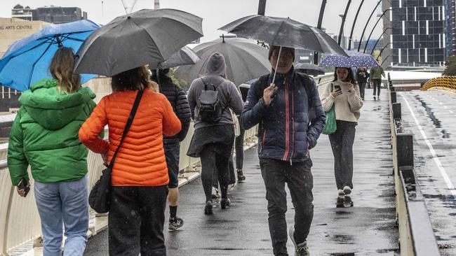 BRISBANE AUSTRALIA - NewsWire NCA Photos JULY 5, 2022: Queenslanders rug up as heavy rain and colder than average temperatures hit Brisbane today. NewsWire / Sarah Marshall