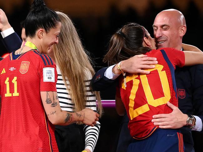 (FILES) Spain's defender #20 Rocio Galvez is congratuled by President of the Royal Spanish Football Federation Luis Rubiales (R) next to Spain's Jennifer Hermoso after winning the Australia and New Zealand 2023 Women's World Cup final football match between Spain and England at Stadium Australia in Sydney on August 20, 2023. Spanish public prosecutors demanded on September 8, 2023 that suspended football chief Luis Rubiales be indicted for sexual assault over his unsolicited kiss on the lips of player Jenni Hermoso at the Women's World Cup final. (Photo by FRANCK FIFE / AFP)