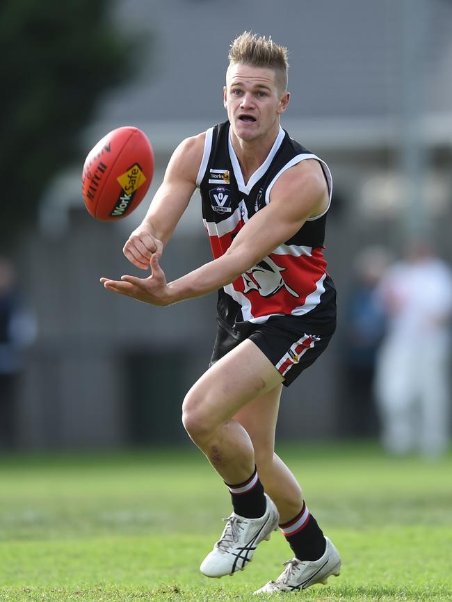 Sharks defender Ben Hogan shoots off a handball. Pictures: Chris Eastman