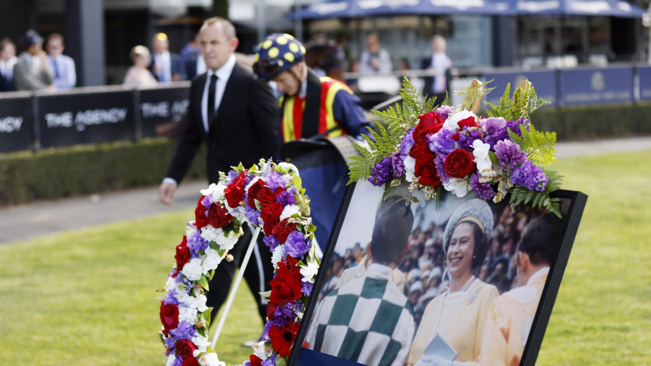 A Floral tribute to Her Majesty Queen Elizabeth II displayed in the mounting yard as Chris Waller and James McDonald walk past at Rosehill Gardens on Saturday.