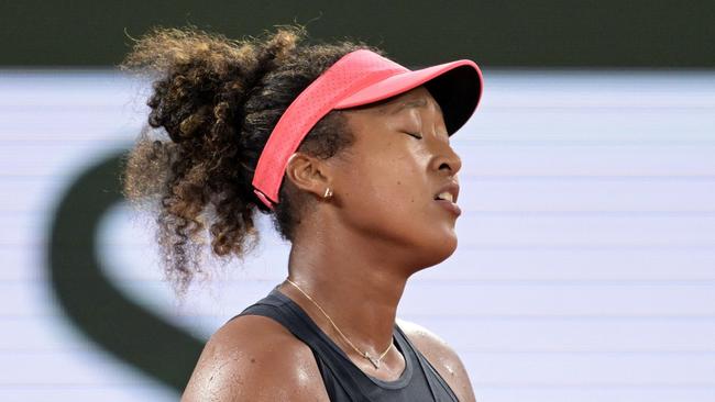 Japan's Naomi Osaka reacts during her women's singles match against Poland's Iga Swiatek on Court Philippe-Chatrier on day four of the French Open tennis tournament at the Roland Garros Complex in Paris on May 29, 2024. (Photo by Bertrand GUAY / AFP)