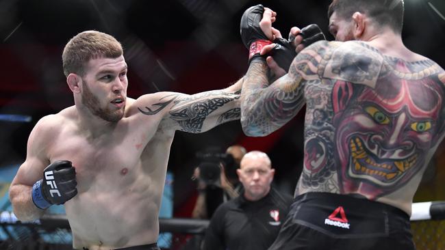 LAS VEGAS, NEVADA - MARCH 06: (L-R) Jake Matthews of Australia punches Sean Brady in their welterweight fight during the UFC 259 event at UFC APEX on March 06, 2021 in Las Vegas, Nevada. (Photo by Chris Unger/Zuffa LLC)