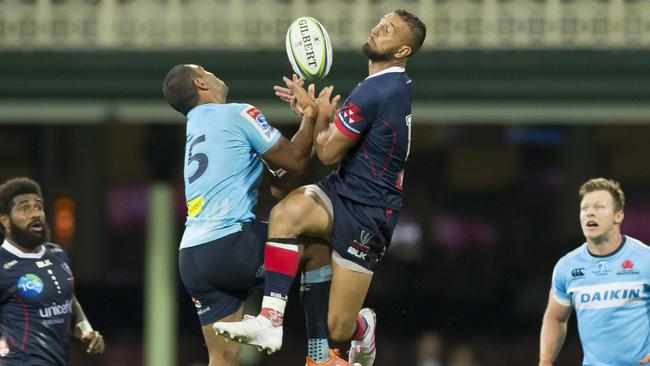 Waratahs fullback Kurtley Beale (left) and Rebels five-eighth Quade Cooper leap for the high ball. Picture: AAP