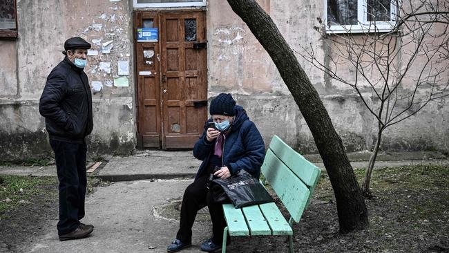 A woman tries to make a phone call in the town of Schastia, near the eastern Ukraine city of Lugansk, a day after Russia recognised east Ukraine's separatist republics. Picture: Aris Messinis / AFP