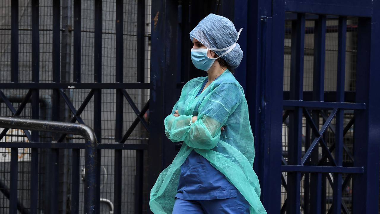 A healthcare worker leaves the entrance of a hospital in Athens, the country’s capital. Picture: Aris Messinis/AFP.