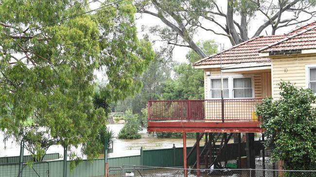 Flood water rising next to a house beside the Georges River in Sydney's south-west on Tuesday. Picture: Getty Images