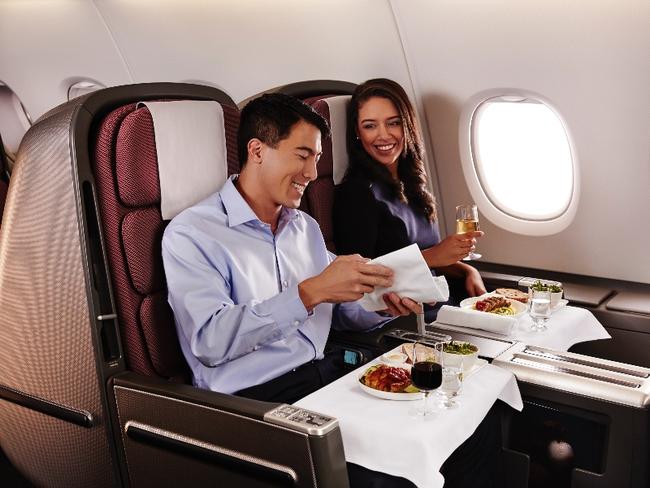 Man and Woman sitting in Business Class on tQantas A380 SkyBed seats. Photo: Qantas.