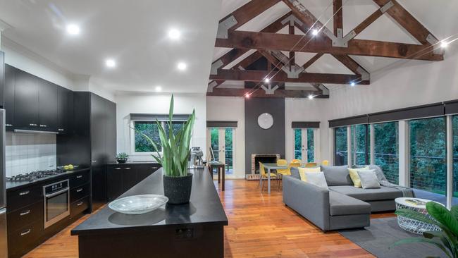 The home’s rear living space is positioned to take in expansive leafy views.