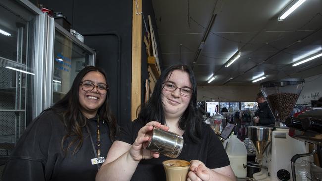 Youth Worker Sara Carbone (left) teaches Volunteer Ash Childs the art of coffee making. Picture: Brett Hartwig