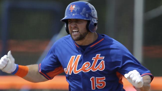 Tim Tebow reacts after hitting a solo home run in his first at bat.