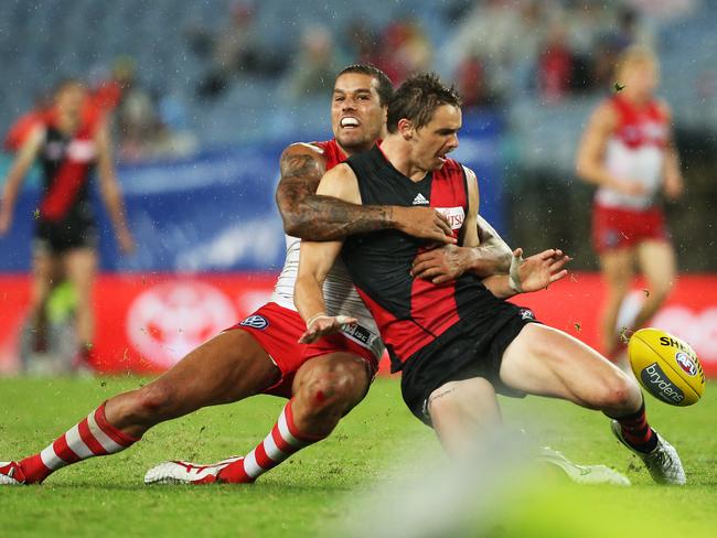 A big tackle by Lance Franklin takes Essendon's Joe Daniher down. Picture: Phil Hillyard