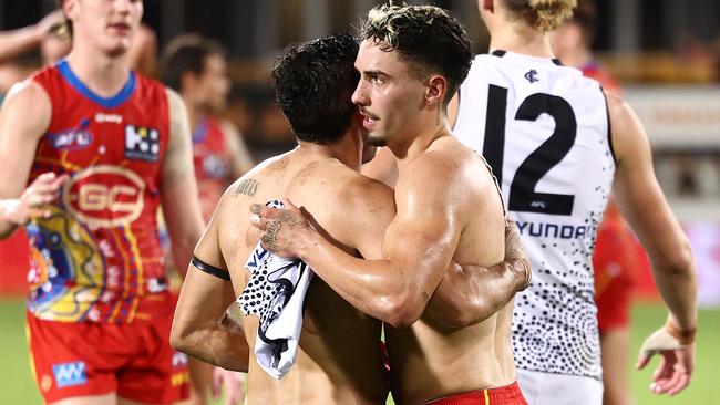 Eddie Betts hugs Izak Rankine as they swap jumpers at the end of the game.