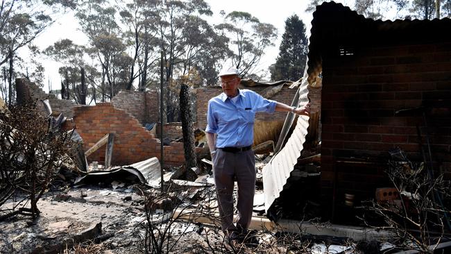 Eugen "Ike" Mjadwesch walking through what remains of his Dargan house. Picture: Sam Mooy