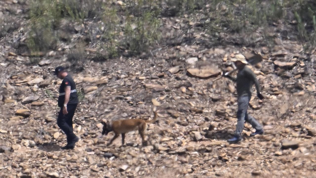 German and Portuguese police members walk with a sniffer dog to the search area by the waterline at Arade reservoir in Silves, Portugal. Picture: Getty