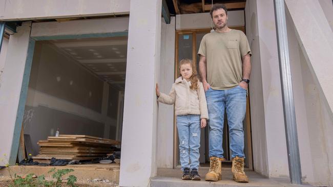 Allan Hirst and his daughter Lyla outside their unfinished home at O'Halloran Hill. Picture: Ben Clark