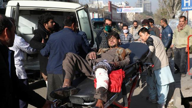 An injured man is carried to a hospital after rockets hit residential areas in Kabul at the weekend. Picture: Reuters