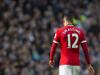 Manchester United's Chris Smalling makes his way from the pitch after being is shown a red card by referee Michael Oliver during his team's English Premier League soccer match against Manchester City at the Etihad Stadium, Manchester, England, Sunday Nov. 2, 2014. (AP Photo/Jon Super)