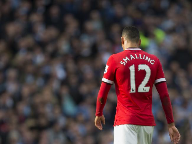 Manchester United's Chris Smalling makes his way from the pitch after being is shown a red card by referee Michael Oliver during his team's English Premier League soccer match against Manchester City at the Etihad Stadium, Manchester, England, Sunday Nov. 2, 2014. (AP Photo/Jon Super)