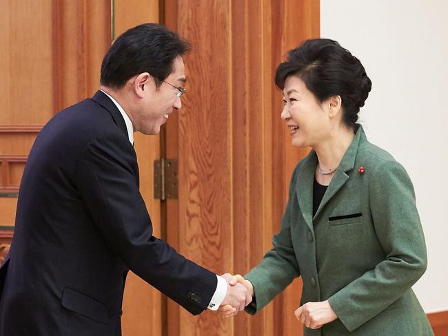 South Korea's President Park Geun-Hye (right) shakes hands with Japanese Foreign Minister Fumio Kishida before their meeting in Korea.