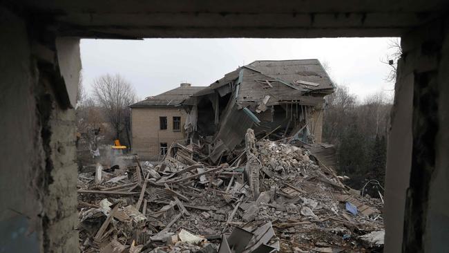 Rescuers clear debris of the destroyed two-storey maternity building in the town of Vilnyansk, in the southern Zaporizhzhia region.