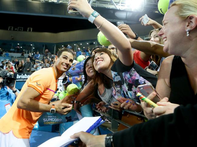 Rafael Nadal signs autographs at the Brisbane International. Picture: Darren England