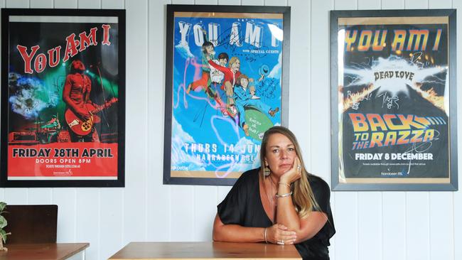 Claire Morris, venue manager of Sydney’s Narrabeen RSL with posters showing You Am I’s previous concerts there. Picture: John Feder