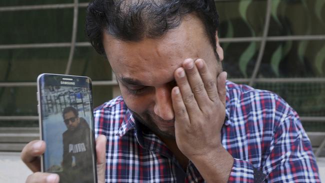 A relative weeps while showing the picture of Sohail Shahid, a Pakistani citizen who was killed in Christchurch mosque shootings. Picture: AP Photo/KM Chaudary
