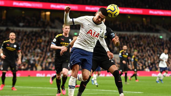 Tottenham’s Dele Alli wins a header ahead of Manchester City’s Riyad Mahrez