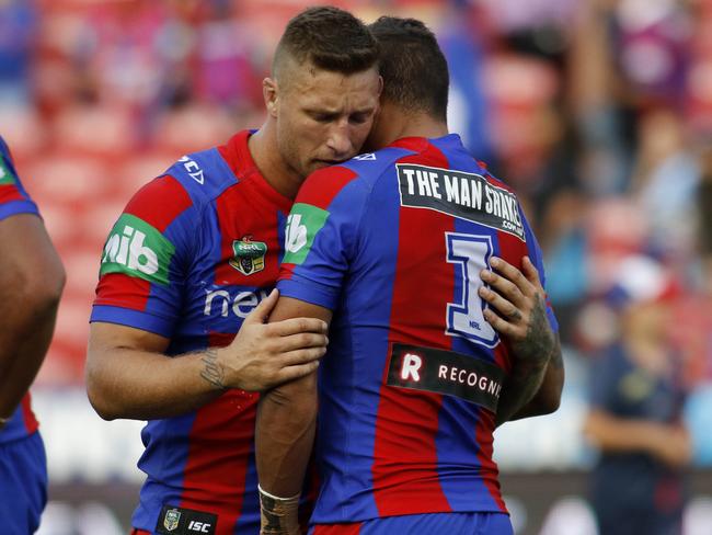 Tariq Sims comforts Dane Gagai after the 62-point thrashing against the Sharks.