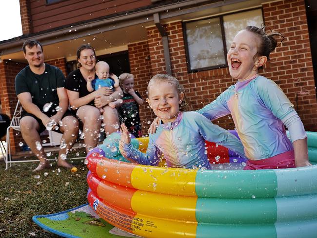 DAILY TELEGRAPH - 30/10/24Delilah and Ellianah Sabjan play in an inflatable pool at their Penrith home today. Parents Matt and Caitlin with brothers George (baby) and Felix in rear. Picture: Sam Ruttyn