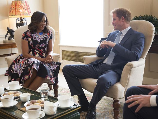 US First Lady Michelle Obama meets Prince Harry at Kensington Palace on June 16, 2015 in London, England. The US First Lady is travelling with her daughters, Malia and Sasha and her mother, Mrs. Marian Robinson, to continue a global tour promoting her ‘Let Girls Learn Initiative’. The event at the school was to discuss how the UK and USA are working together to expand girl’s education around the world. Picture: Getty