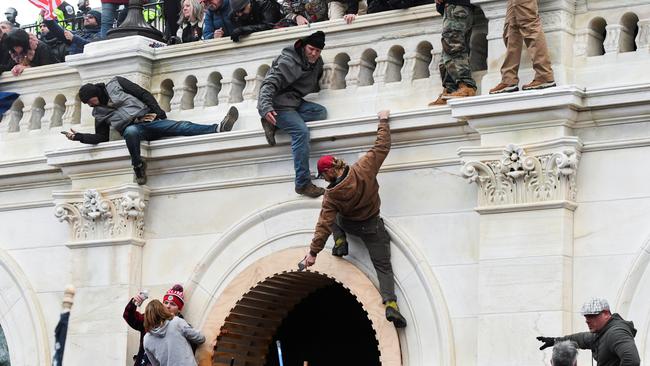 Supporters of Donald Trump climb on walls at the U.S. Capitol. Picture: Reuters/Stephanie Keith