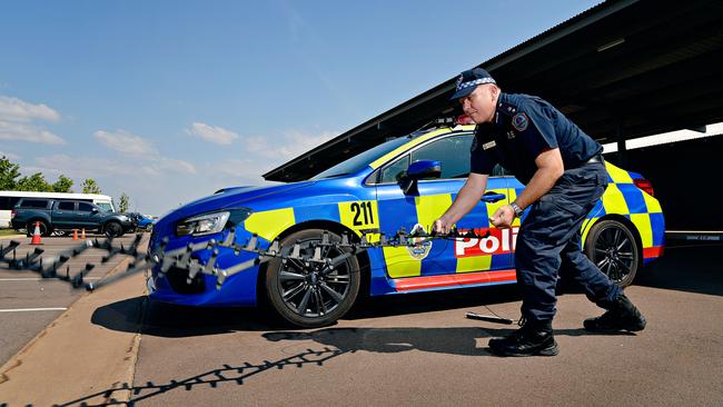 Road Policing Superintendent Daniel Shean demonstrates the Stinger tire deflation device. (FILE PHOTO)