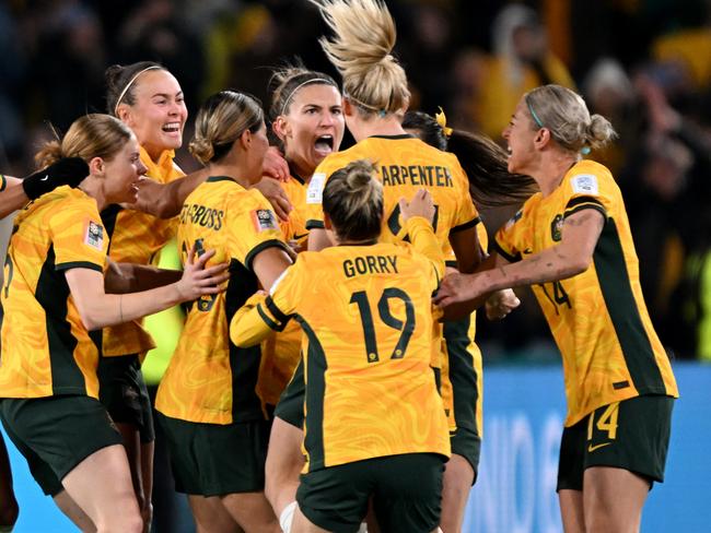 SYDNEY, AUSTRALIA - JULY 20: Australia players celebrate the team's first goal scored by Steph Catley (obscured) during the FIFA Women's World Cup Australia & New Zealand 2023 Group B match between Australia and Ireland at Stadium Australia on July 20, 2023 in Sydney, Australia. (Photo by Bradley Kanaris/Getty Images)