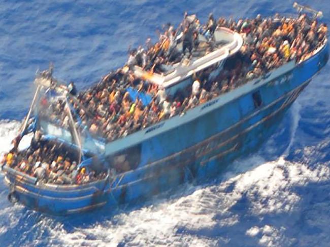This image released by The Hellenic Coastguard on June 14, 2023, shows an aerial view taken from a rescue helicopter, of migrants onboard a fishing vessel in the waters off the Peloponnese coast of Greece on June 13, 2023. At least 79 migrants died after their fishing boat sank off the Peloponnese, Greece's coastguard said, as fears mounted that the death toll could rise much higher. (Photo by HELLENIC COASTGUARD / AFP) / RESTRICTED TO EDITORIAL USE - MANDATORY CREDIT 