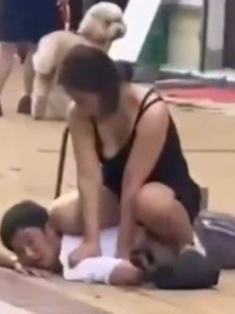 Footage showed the woman pinning a customer down on the sidewalk in China. Picture: Viral Press