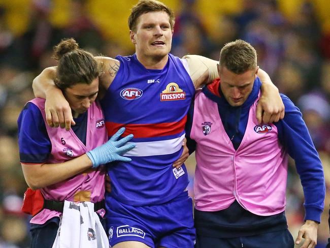 Jack Redpath is helped off after injuring his knee against St Kilda.